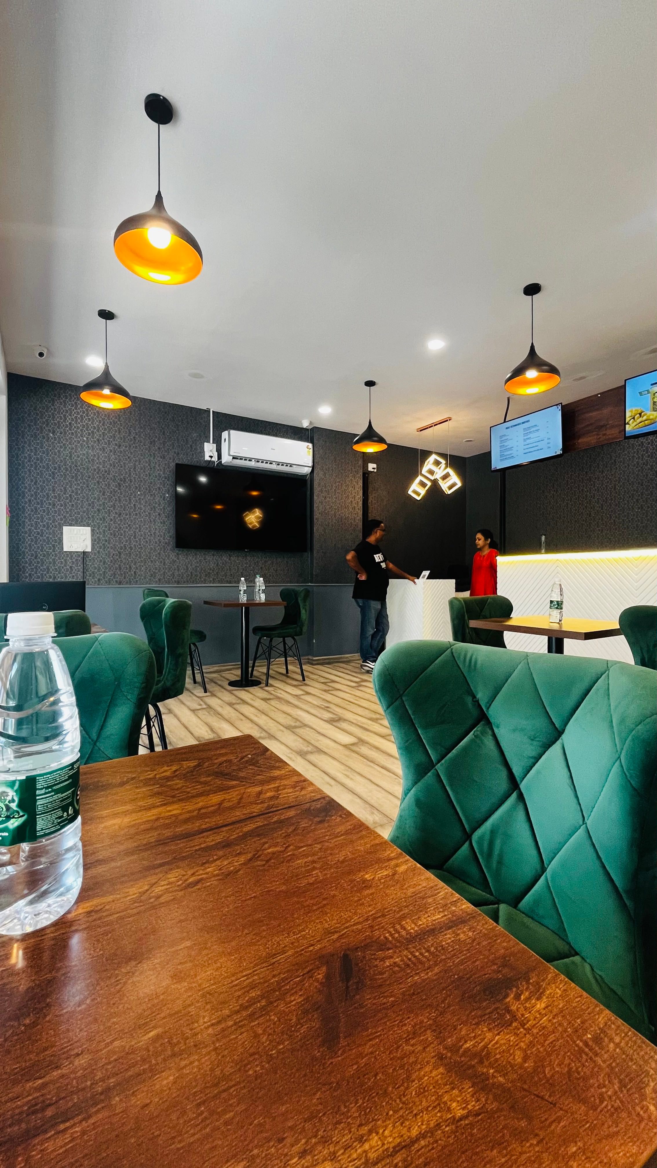 Completed Amaiga seating area with green chairs and service counter
